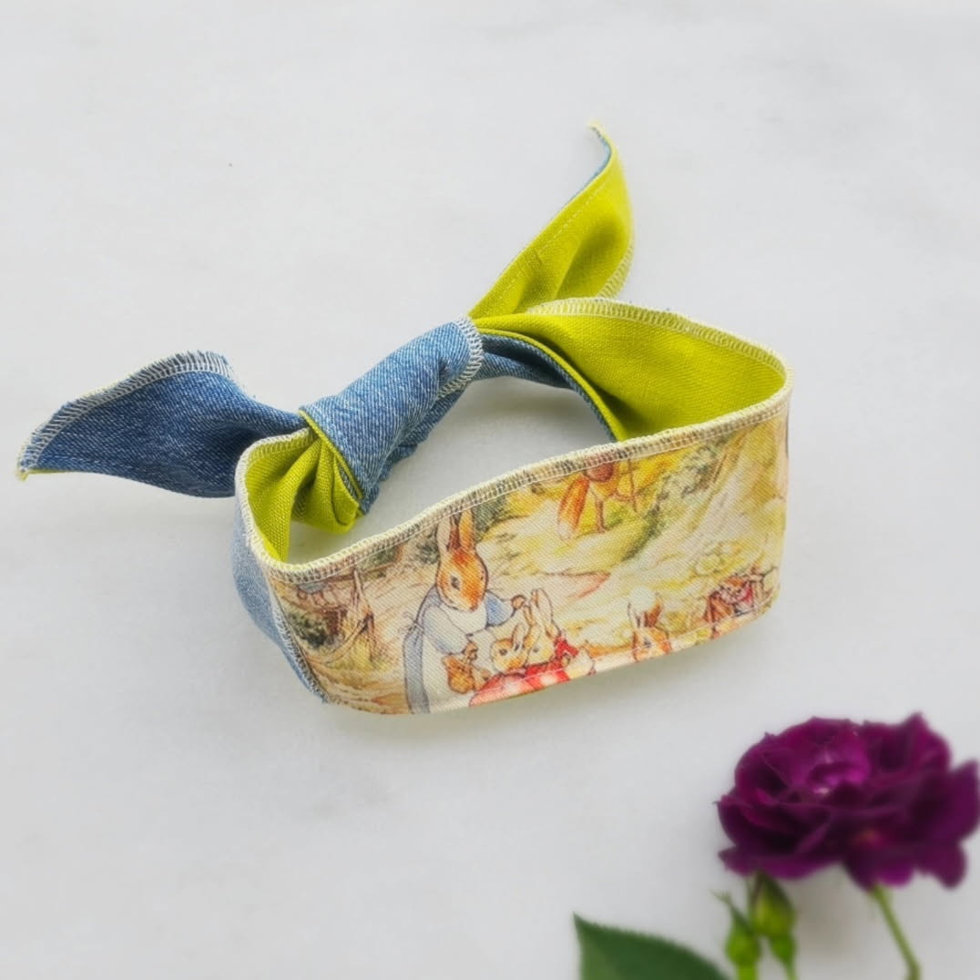 Colorful fabric and denim dog scarf with rabbit design on a white background