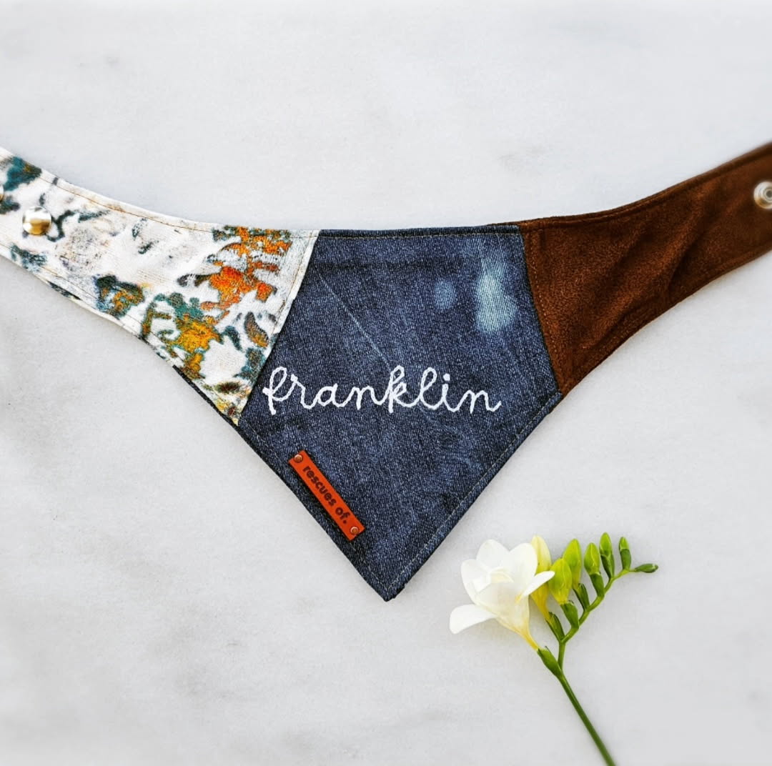 Franklin rescue dog bandana with floral, denim, and brown sections on a light background